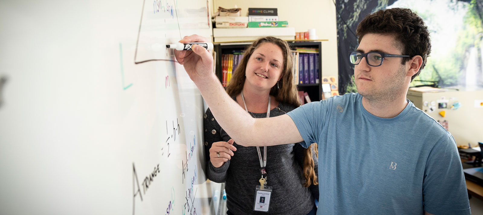 Teacher and student at whiteboard